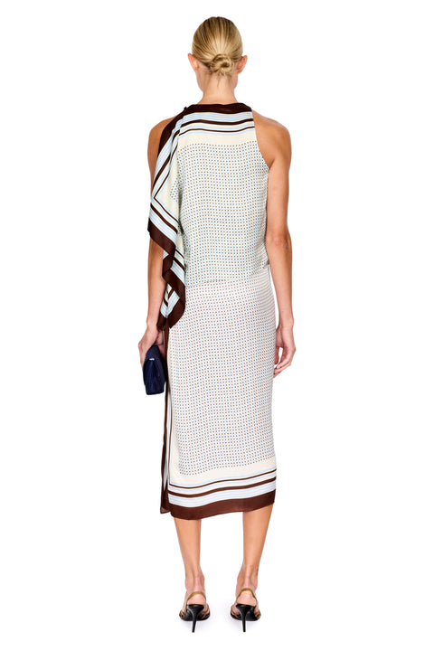 A woman shown from the back wearing a sleeveless two piece skirt set with a cream base, brown and black striped border, and draped shoulder detail. She is standing against a plain white background.