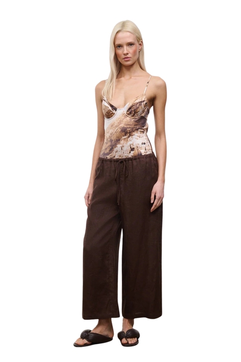 Woman wearing brown drawstring wide-leg pants on a white background