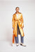 Metallic orange trench coat on a model
