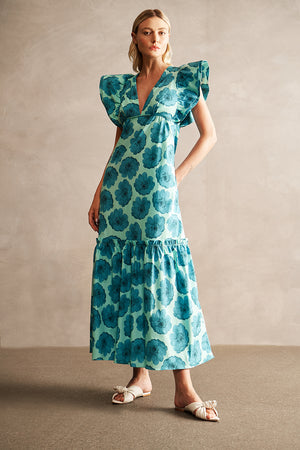 Teal and blue long dress with ruffle sleeves on a model