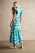 Back of the teal and blue long floral dress on a model