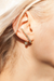 A model wearing the Aurelia Earrings, showing how they wrap the ear uniquely.  