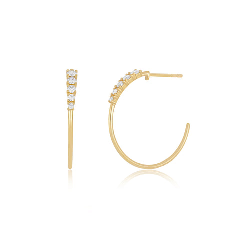 Yellow gold and diamond hoops on a white background