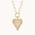 Up-close view at the heart charm against a white background to emphasize the charm details
