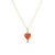 Close-up view of the Carnelian Byrdie Heart charm placed on a yellow gold chain.  