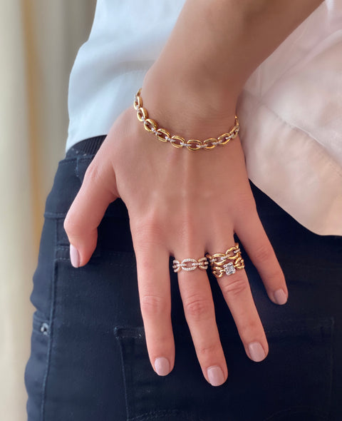 The Catena YG Ring paired with matching rings and bracelets on a model.  